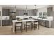 Modern kitchen with stainless steel appliances, gray cabinetry, and a spacious center island at 108 N Stonemill Trl # Homesite 254, Wilson's Mills, NC 27520