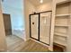 Bathroom featuring a shower with a glass door, a bathtub, and open shelving at 108 N Stonemill Trl # Homesite 254, Wilson's Mills, NC 27520