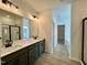 Bathroom featuring double sinks, quartz countertops, modern fixtures, and a separate shower area at 108 N Stonemill Trl # Homesite 254, Wilson's Mills, NC 27520