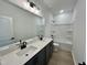 Modern bathroom features double sinks and a tub-shower combo at 108 N Stonemill Trl # Homesite 254, Wilson's Mills, NC 27520