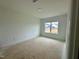 Bedroom with a large window and neutral paint at 108 N Stonemill Trl # Homesite 254, Wilson's Mills, NC 27520