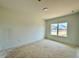 Bedroom showing a light-filled space with a window overlooking the neighborhood at 108 N Stonemill Trl # Homesite 254, Wilson's Mills, NC 27520