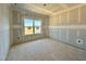 Unfinished bedroom with large window offering lots of natural light and neighborhood views at 108 N Stonemill Trl # Homesite 254, Wilson's Mills, NC 27520
