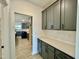 Butler's pantry with gray cabinets, ample counter space, and easy access to the kitchen at 108 N Stonemill Trl # Homesite 254, Wilson's Mills, NC 27520