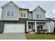 New construction two-story home featuring a two-car garage, stone accents and gray siding at 108 N Stonemill Trl # Homesite 254, Wilson's Mills, NC 27520