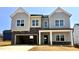 Newly constructed two-story home featuring gray siding, stone accents, and an attached two-car garage at 108 N Stonemill Trl # Homesite 254, Wilson's Mills, NC 27520