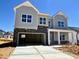 New construction home featuring gray siding, stone accents, and an attached two-car garage at 108 N Stonemill Trl # Homesite 254, Wilson's Mills, NC 27520