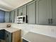 Modern kitchen featuring gray cabinets, stainless microwave, and light countertops at 108 N Stonemill Trl # Homesite 254, Wilson's Mills, NC 27520