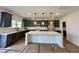 Modern kitchen featuring gray cabinets, stainless appliances, an island, and modern lighting at 108 N Stonemill Trl # Homesite 254, Wilson's Mills, NC 27520