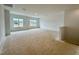 A spacious living room features large windows and plenty of natural light at 108 N Stonemill Trl # Homesite 254, Wilson's Mills, NC 27520