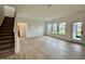 Bright living room boasts hardwood floors, large windows and a staircase to the second floor at 108 N Stonemill Trl # Homesite 254, Wilson's Mills, NC 27520