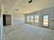 Bright living room featuring several windows for abundant natural light at 108 N Stonemill Trl # Homesite 254, Wilson's Mills, NC 27520