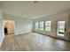 Bright living room featuring hardwood floors and multiple windows that flood the space with natural light at 108 N Stonemill Trl # Homesite 254, Wilson's Mills, NC 27520