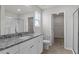Well-lit bathroom featuring a granite countertop vanity, toilet, and glass-door shower at 110 Rhino Bnd, Oxford, NC 27565