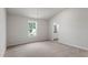 Sunlit bedroom featuring plush carpet, a window view, and a glimpse into the bathroom at 110 Rhino Bnd, Oxford, NC 27565