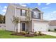 Charming two-story home with a well-manicured lawn and a two-car garage, enhanced by tasteful landscaping at 110 Rhino Bnd, Oxford, NC 27565