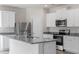 Kitchen featuring granite countertops, stainless steel appliances, a range hood and white cabinets at 110 Rhino Bnd, Oxford, NC 27565