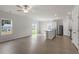 Bright living room featuring wood flooring, a large window for ample natural light and an adjacent modern kitchen at 110 Rhino Bnd, Oxford, NC 27565
