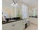 Elegant bathroom with double vanities, granite countertops, and a large window with natural light at 1115 Wake Forest Rd # B, Raleigh, NC 27604