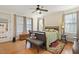 Bedroom with hardwood flooring, ceiling fan and bench at the end of the bed at 1115 Wake Forest Rd # B, Raleigh, NC 27604