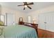 Bedroom with hardwood flooring, ceiling fan and natural light at 1115 Wake Forest Rd # B, Raleigh, NC 27604