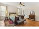 Bedroom with hardwood flooring, ceiling fan and bench at the end of the bed at 1115 Wake Forest Rd # B, Raleigh, NC 27604