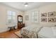 Charming bedroom with hardwood floors, complemented by natural light from shuttered windows at 1115 Wake Forest Rd # B, Raleigh, NC 27604