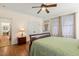 Bright bedroom featuring hardwood floors, a ceiling fan, and access to the outdoors at 1115 Wake Forest Rd # B, Raleigh, NC 27604