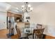 The dining room has hardwood floors and a glass dining table with seating and chandelier at 1115 Wake Forest Rd # B, Raleigh, NC 27604
