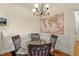 Cozy dining area with a round table, chandelier, and wainscoting, perfect for Gathering meals at 1115 Wake Forest Rd # B, Raleigh, NC 27604