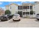 Two-story home exterior with white railings and porch, multiple parked cars, and tidy landscaping at 1115 Wake Forest Rd # B, Raleigh, NC 27604