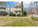 Two-story home featuring double porches, manicured hedges, and lush lawn, creating curb appeal at 1115 Wake Forest Rd # B, Raleigh, NC 27604