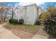 Side exterior view of a two-story brick and siding home with landscaping, sidewalk, and partial driveway at 1115 Wake Forest Rd # B, Raleigh, NC 27604