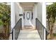 Close-up of the front door with decorative columns and a leaded glass window for added curb appeal at 1115 Wake Forest Rd # B, Raleigh, NC 27604