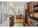 Kitchen with granite countertops, stainless steel appliances, wood cabinets and hardwood flooring at 1115 Wake Forest Rd # B, Raleigh, NC 27604