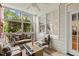 Cozy sunroom with large windows, comfortable seating, and a ceiling fan for relaxing afternoons at 1115 Wake Forest Rd # B, Raleigh, NC 27604