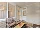 Relaxing sunroom featuring neutral tones, cushioned furniture, and outdoor views through bright windows at 1115 Wake Forest Rd # B, Raleigh, NC 27604