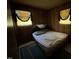 Simple bedroom with a bed, carpet flooring, and natural light from two windows at 113 Smith St, Four Oaks, NC 27524