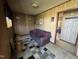 Cozy living room features wood paneling, plush sofa, and a patterned area rug at 113 Smith St, Four Oaks, NC 27524