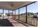 Spacious screened-in back porch with wooden flooring, a ceiling fan, and scenic outdoor views at 118 Riverwood Dr, Fuquay Varina, NC 27526