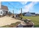 Expansive backyard featuring string lights, patio space, grilling area, and landscaping at 118 Riverwood Dr, Fuquay Varina, NC 27526