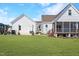 Expansive backyard featuring a covered porch, an outdoor grill and a charming pergola strung with lights at 118 Riverwood Dr, Fuquay Varina, NC 27526