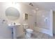 Bathroom featuring pedestal sink, round mirror, toilet, and tiled floor at 118 Riverwood Dr, Fuquay Varina, NC 27526