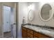 Bathroom with double sink vanity, granite countertop, and decorative oval mirrors at 118 Riverwood Dr, Fuquay Varina, NC 27526