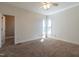Spacious bedroom with two windows, neutral carpet, base trim and a ceiling fan at 118 Riverwood Dr, Fuquay Varina, NC 27526