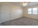 Bright bedroom with neutral carpet, ceiling fan, and natural light from a window at 118 Riverwood Dr, Fuquay Varina, NC 27526