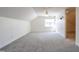 Spacious carpeted bonus room featuring ample natural light and versatile living space at 118 Riverwood Dr, Fuquay Varina, NC 27526