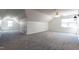 Expansive bonus room with high ceilings, neutral carpet, and natural light streaming through windows at 118 Riverwood Dr, Fuquay Varina, NC 27526