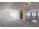 Expansive bonus room, featuring a ceiling fan, natural light, and an open layout at 118 Riverwood Dr, Fuquay Varina, NC 27526