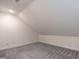 Attic bonus room with neutral paint, plush carpet, and ample natural light at 118 Riverwood Dr, Fuquay Varina, NC 27526
